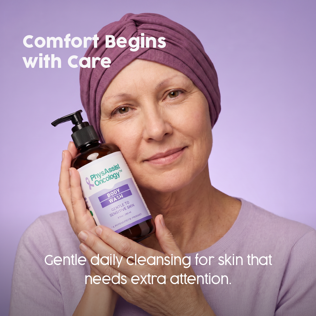 A woman wearing a mauve headwrap and matching top holds a bottle of PhysAssist Body Wash against a lavender background, with promotional text reading 'Comfort Begins with Care' and 'Gentle daily cleansing for skin that needs extra attention.'